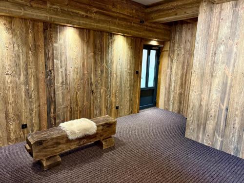 a room with a bench with a furry pillow on it at Pension U Studny in Harrachov