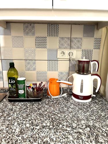 a kitchen counter with a coffee maker and a tea kettle at Cozy Apartment Near Oldtown Antalya in Antalya