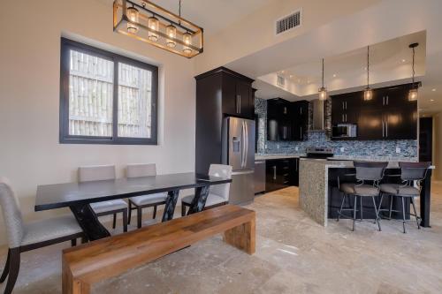 a kitchen with a table and chairs and a counter at Diamante Beachfront Suites in San Pedro