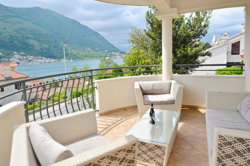 a balcony with a view of a river and mountains at SEA VIEW apartment 2km from the Old Town of Kotor in Dobrota
