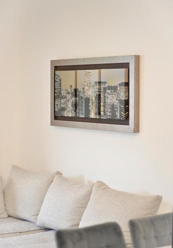 a living room with a couch and a picture on the wall at SEA VIEW apartment 2km from the Old Town of Kotor in Dobrota
