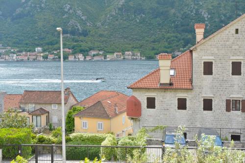 a group of houses next to a body of water at SEA VIEW apartment 2km from the Old Town of Kotor in Dobrota