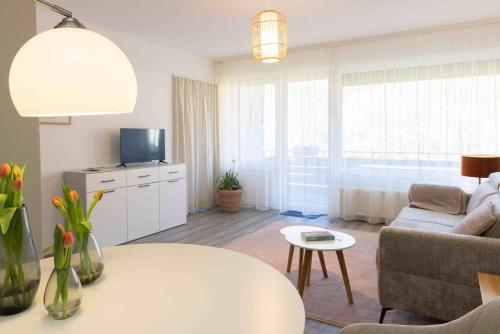 a living room with a couch and a table at Herzlichstharz - Klein und Fein in Bad Lauterberg