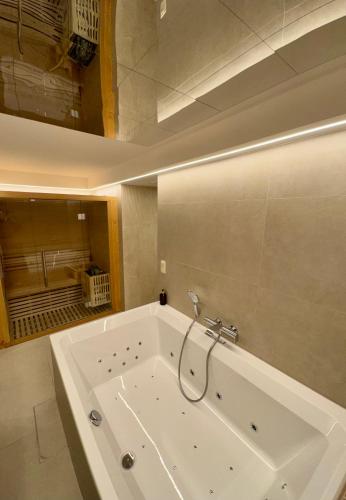 a large white bath tub in a bathroom at Hotel de Maître de Vaughan in Brussels