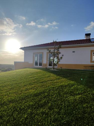 a house with a green lawn in front of it at Natural Park Heights in São João das Lampas