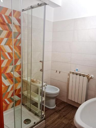 a bathroom with a toilet and a glass shower at Brezza Marina Studios in Montesilvano