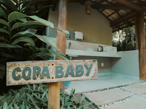 a sign that reads copa baby in front of a house at Carambola Hotel in Arraial d'Ajuda
