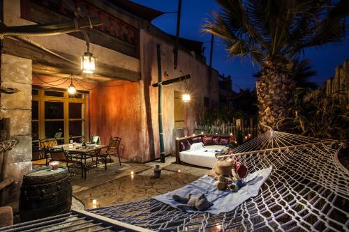 two teddy bears sitting in a hammock in a patio at Hôtel Cap Pirate in Cap d'Agde