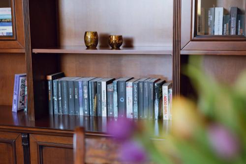 a book shelf with a bunch of books on it at Seaside "Stone & Light Villa" close to Aegina City in Khlóï