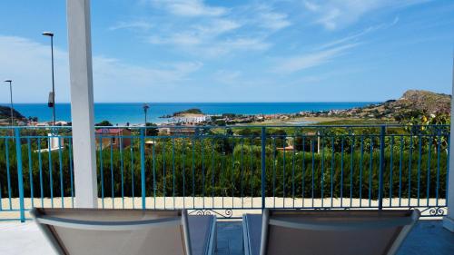 a balcony with two chairs and a view of the ocean at Sole Mare - Casa Vacanze Chiavarello in Licata