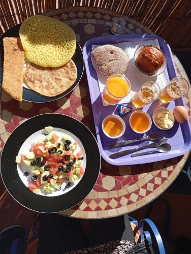 a table with two trays of breakfast food on it at Studio Dar ziane in El Jadida