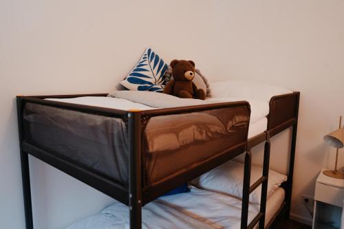 a teddy bear sitting on top of a bunk bed at Aprießnig Apartments in Fürnitz