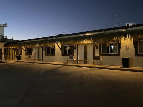 a building with a parking lot in front of it at Rio inn in Delicias