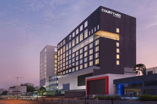 a tall black building with a sign on it at Courtyard by Marriott Ranchi in Rānchī