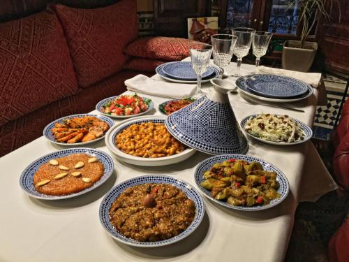 a table with many plates of food on it at Riad Le Calife in Fès