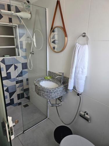 ein Badezimmer mit Waschbecken und Dusche in der Unterkunft Casa familiar lado do Santuário Nacional de Aparecida SP in Aparecida