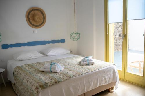 a bedroom with a bed with towels on it at Kastellas' Dream in Kithnos