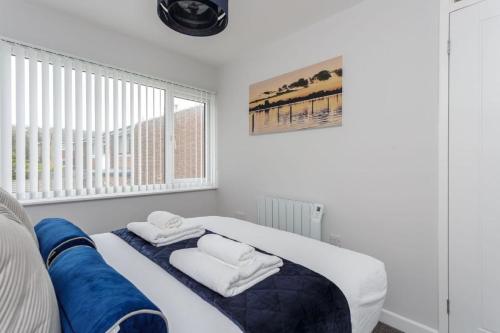 a white room with a bed with towels on it at Castle View - 2 Bed Stylish Coastal Port Solent Retreat with Views! Parking, Sleeps 6 - By Blue Puffin Stays in Portsmouth