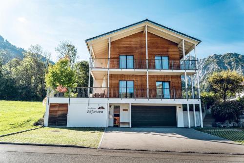 a large wooden house with a garage at Landhaus Valfontana in Vandans