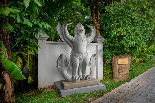 a statue of a woman with her hands in the air at The Embassy Angkor Resort & Spa in Siem Reap