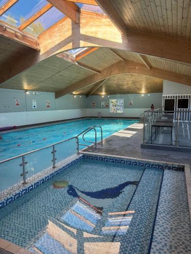 a large indoor swimming pool with a large indoor swimming pool at Lovely Serenity 1 and 2 caravans are situated on the Norfolk Broads in Lowestoft