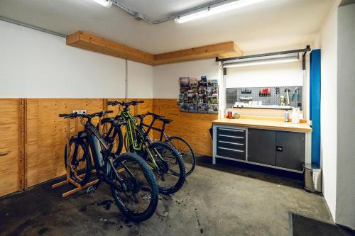 two bikes parked in a room with a kitchen at Landhaus Valfontana in Vandans