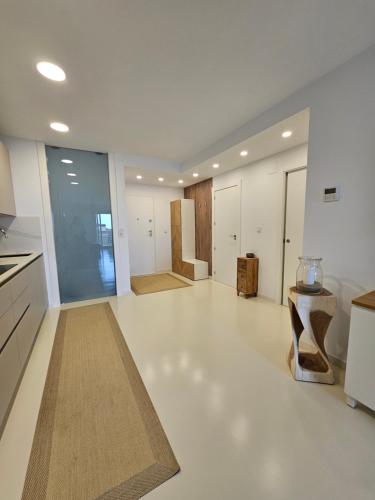a large kitchen with white floors and white appliances at Modern Appartement Alenda Golf in Monforte del Cid