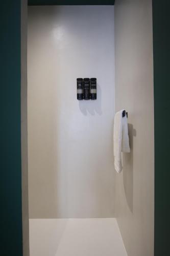 a white bathroom with a tub and a toilet at Maison Bello - Chic in Beaupréau
