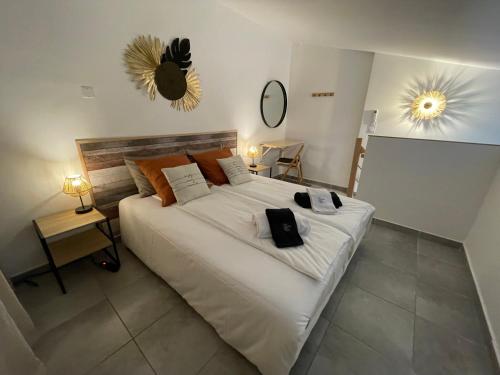 a bedroom with a large white bed with towels on it at Villa A CASA DI LO in Lecci