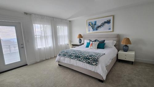 a bedroom with a bed with pillows and a window at Modern Zen House, EV Plugin, Mountains, Trails & Stylish Urban Vibe in Coquitlam