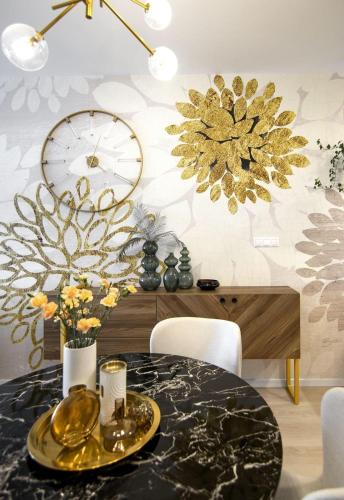 a dining room with a black table and gold decorations at LAM Gold- Terrace - Free Parking in Považská Bystrica