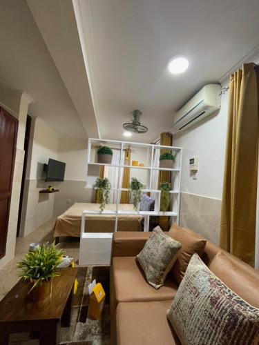 a living room with a couch and a table at Mikocheni Comfort I Dar es Salaam, Tanzania in Dar es Salaam