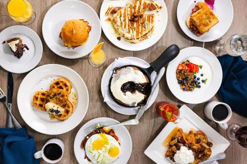 a table with white plates of breakfast food at Dunhill Hotel in Charlotte