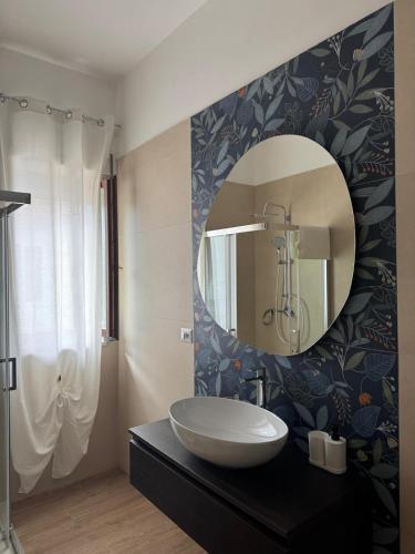 a bathroom with a sink and a mirror at PiTer House - Luxury Apartments & Private Parking in Lusciano