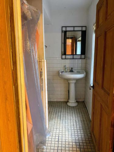 a bathroom with a sink and a mirror at Kelly Lodging in Baltimore