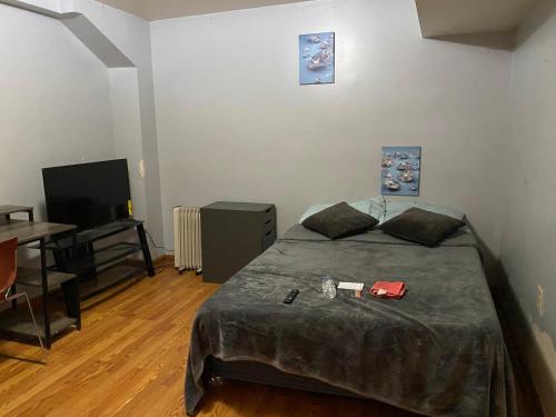 a bedroom with a bed and a table and a television at Kelly Lodging in Baltimore