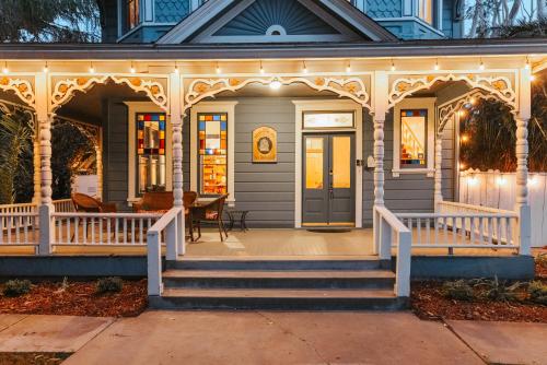 a house with a front porch with a staircase at Kaleidoscope Inn & Gardens in Nipomo