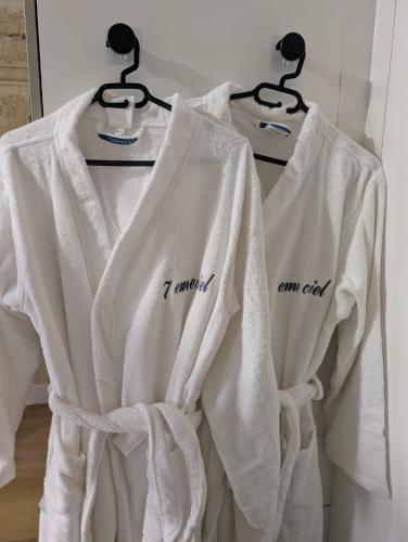 a group of white towels hanging on a rack at Suite avec jacuzzi privatif in Vergèze