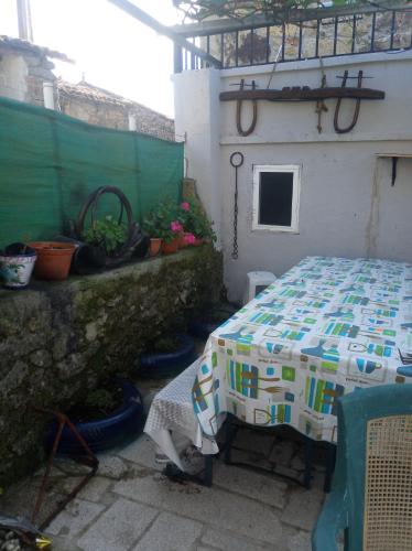 a patio with a table with a quilt on it at Casa Nodar in Chantada