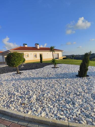 a gravel driveway with a house in the background at Natural Park Heights in São João das Lampas
