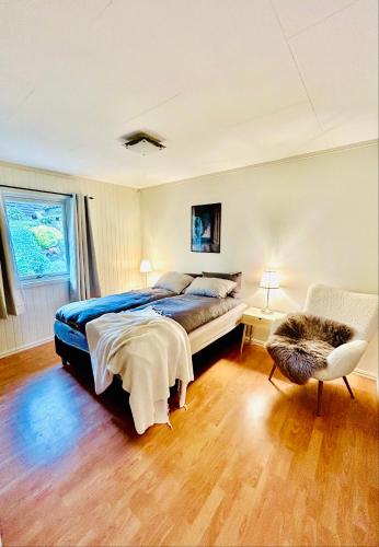 a bedroom with a bed and a chair at Casa Troll in Tromsø