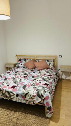 a bedroom with a bed with a colorful comforter at La Casa del Borgo in Rieti