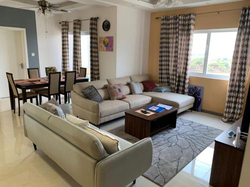 a living room with a couch and a table at Ocean View Apartments in Sakumona
