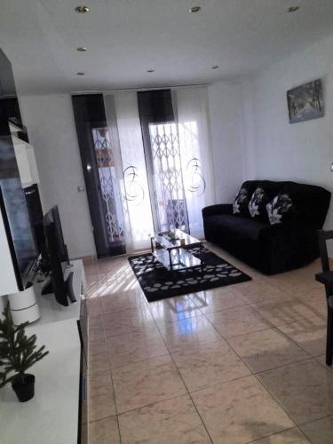 a living room with a couch and a coffee table at Sweet house close to airport in El Prat de Llobregat