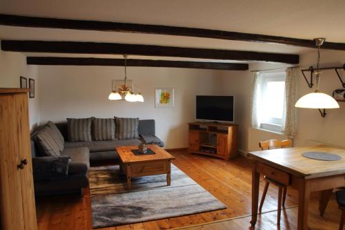 a living room with a couch and a table at Ferienwohnung Hochwaldblick in Hörnitz