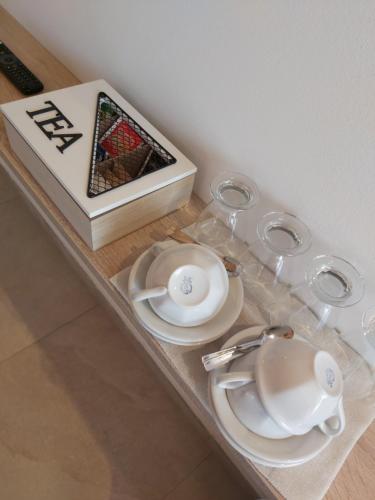 a table with plates and glasses and a box at Cascina Olmetto di Sotto in Ghedi