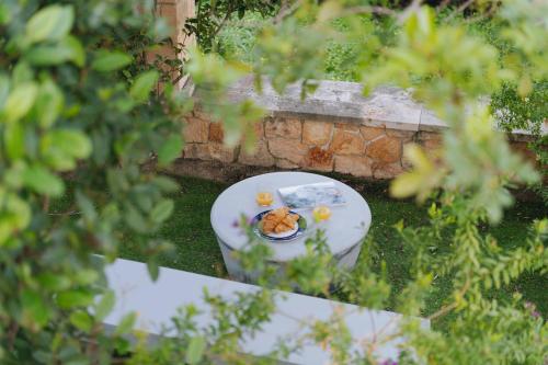 a plate of food on a table in a garden at Seaside "Stone & Light Villa II" close to Aegina City in Khlóï