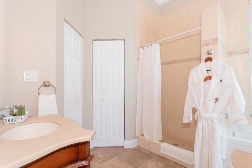 a bathroom with a white robe hanging on a rack at Shangri-La Boutique Bed & Breakfast in West Bay