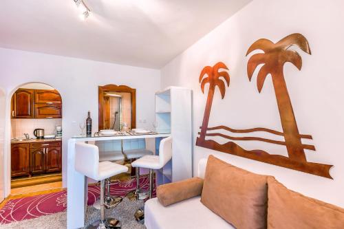 a living room with a couch and a desk at Villa Roses Apartments & Wellness in Ičići