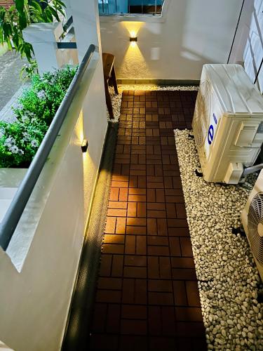 a hallway with a tile floor and a bench at Rattanasup House in Hat Yai